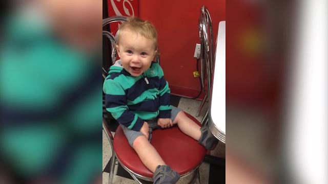 A Tot Boy Takes Bites Of Ice Cream And Makes A Funny Laugh