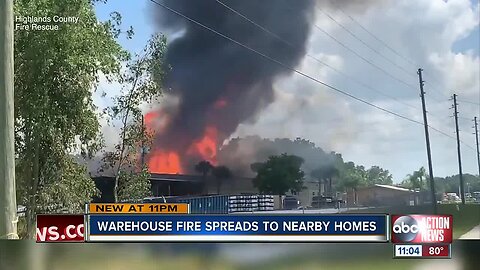 Warehouse fire spreads to nearby homes