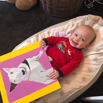 Dog and baby boy share precious moment together