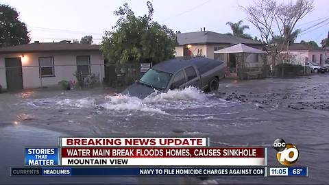 Water main break floods homes, causes sinkhole