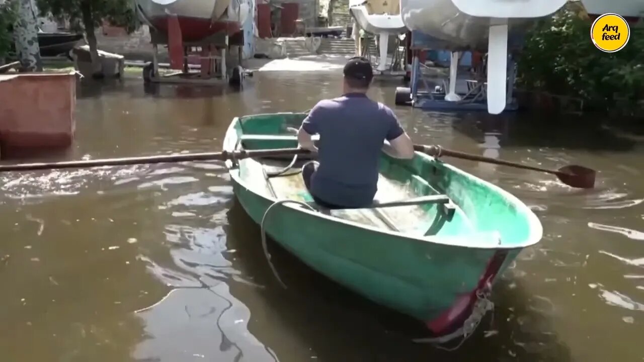 People using boats on flooded streets in Ukraine's Mykolaiv