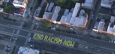 Protesters paint 'end racism now'