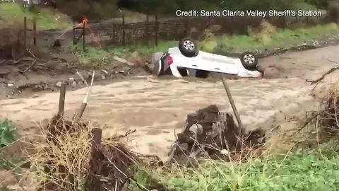 Fast-moving floodwaters overturn vehicle in Santa Clarita