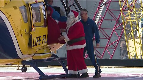 Santa Claus lands in a helicopter at Metrohealth to deliver presents to kids