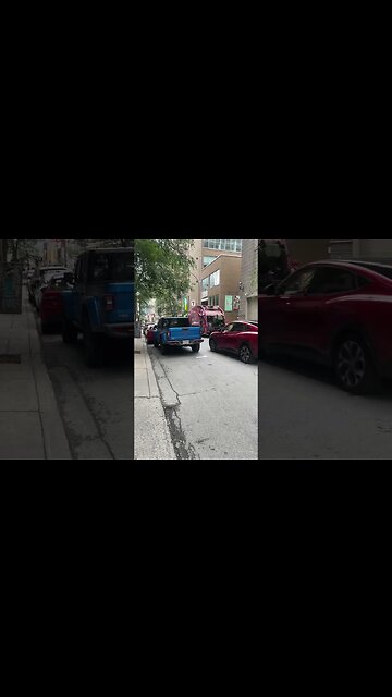 Garbage truck collector in action downtown Montréal