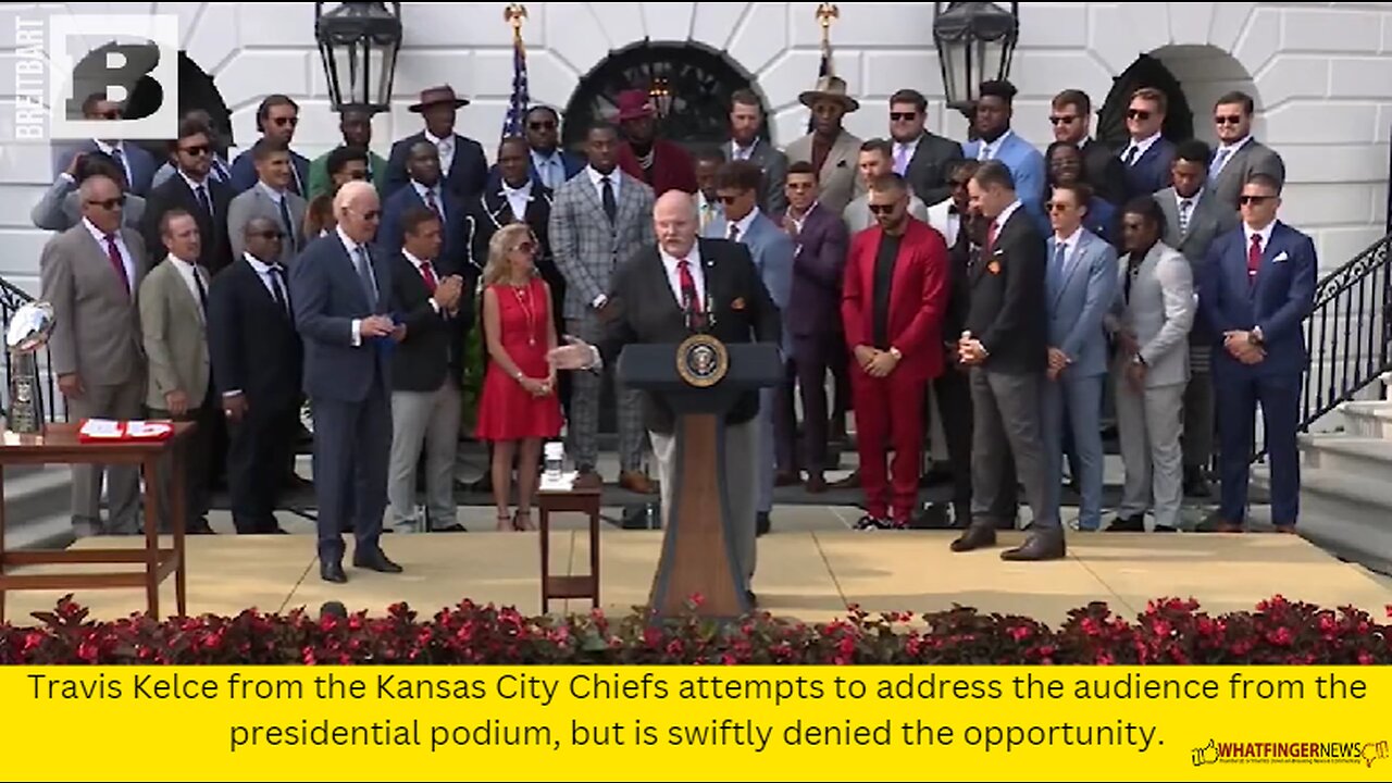 Travis Kelce from the Kansas City Chiefs attempts to address the audience from the presidential