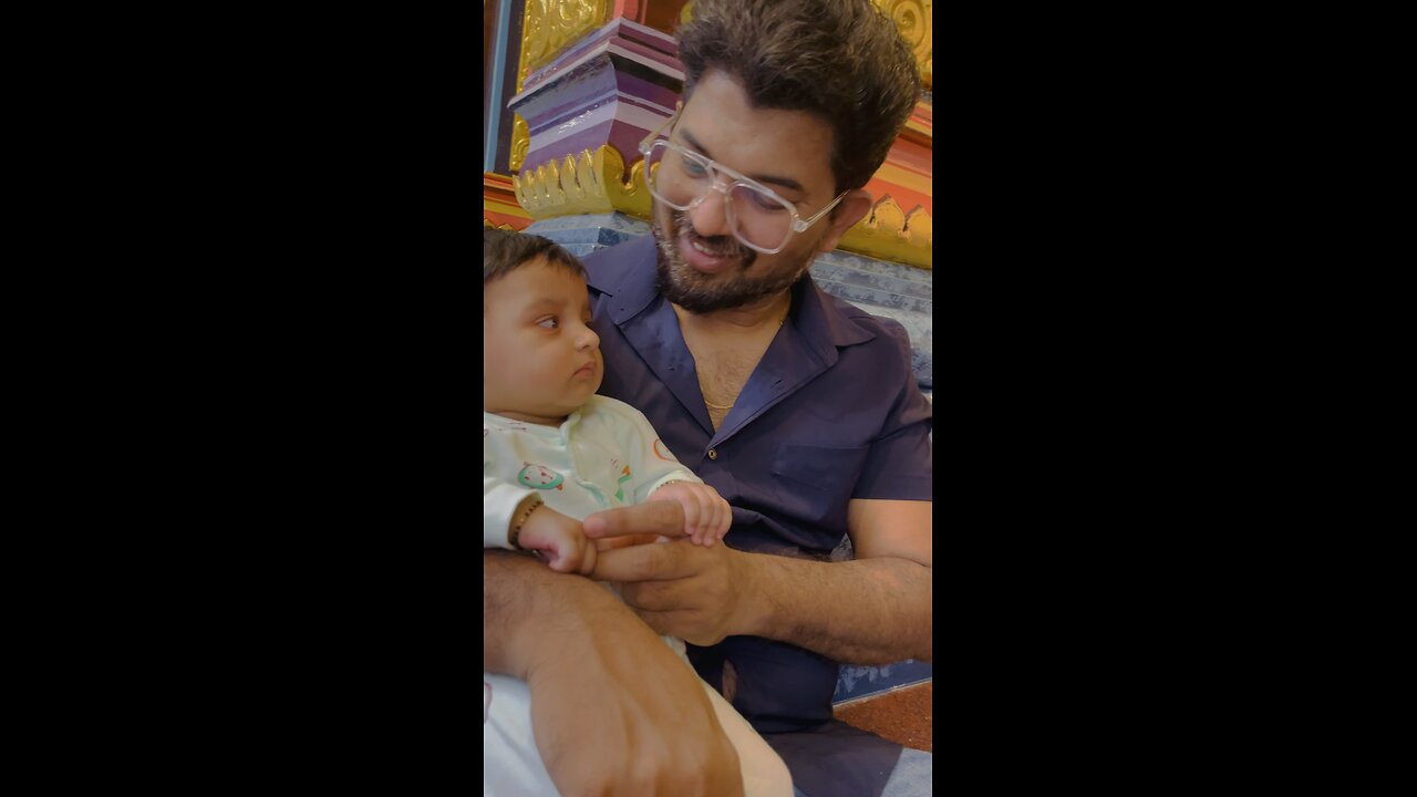 Little baby Aira listening to the bhajana in the temple.