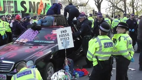 police on the roofs of a car removing protester #metpolice