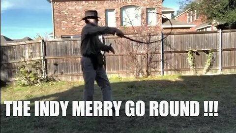 INDIANA JONES IMPERSONATOR MIKE GOLDBERG DEMONSTRATING THE OVERHEAD CRACK MERRY GO ROUND