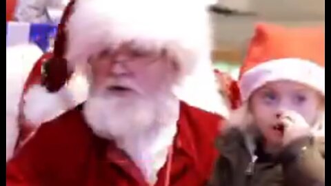 Santa realizes little girl is deaf & starts talking to her in sign language