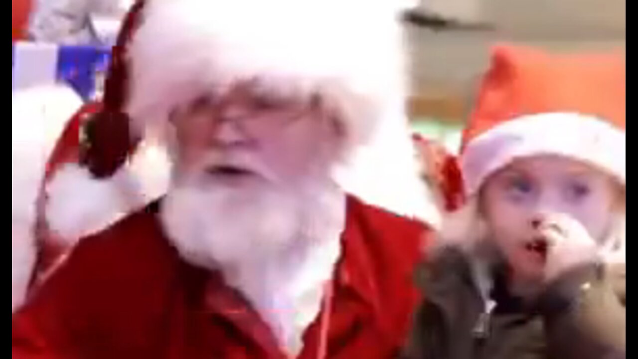 Santa realizes little girl is deaf & starts talking to her in sign language