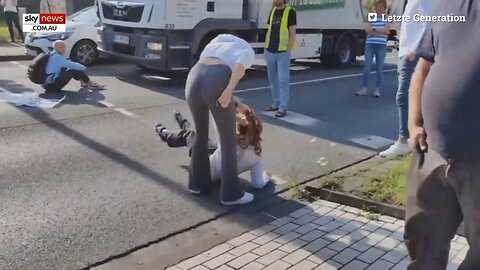 Woman drags climate activist by the hair to stop her from blocking traffic | Sky News