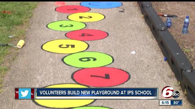 Volunteers build new playground at IPS school