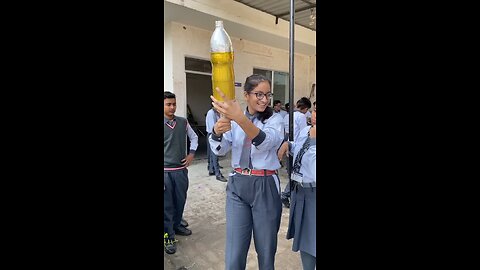 Water bottle rocket launch by girl