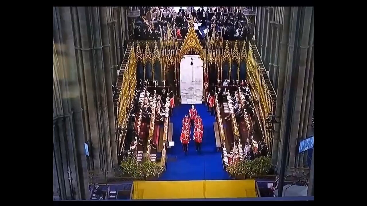 Weird figure crosses the doorway at the kings coronation