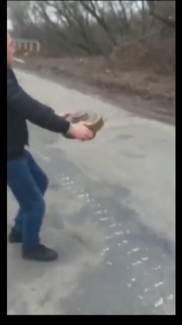 Ukrainian man relocating a mine with bare hands