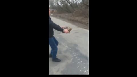 Ukrainian man relocating a mine with bare hands