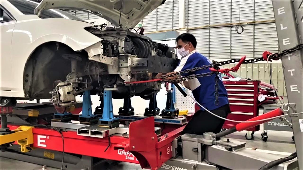 Damaged Mazda 3 on job repair training setup on a Celette car bench with Cameleon universal jigs