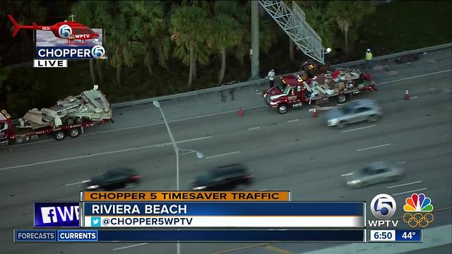 Crews clear debris off I-95 after car with trailer crashes