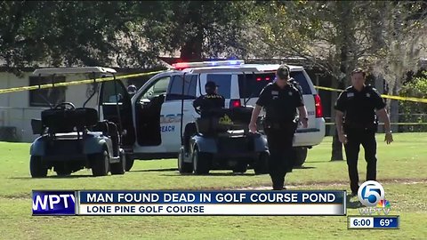 Officials pull a body from a lake at Riviera Beach golf course