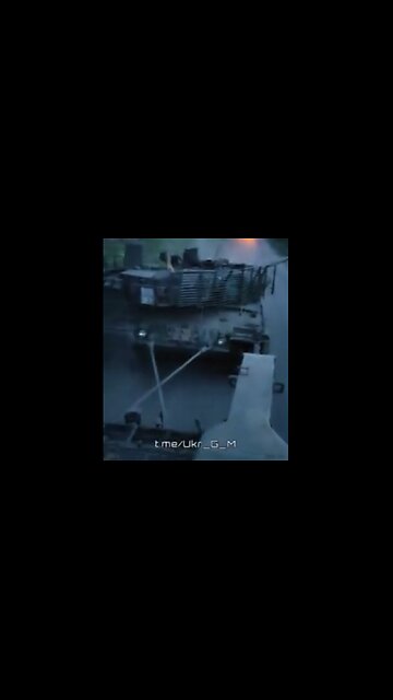 Russian soldiers towing a captured Ukrainian Leopard 2 tank