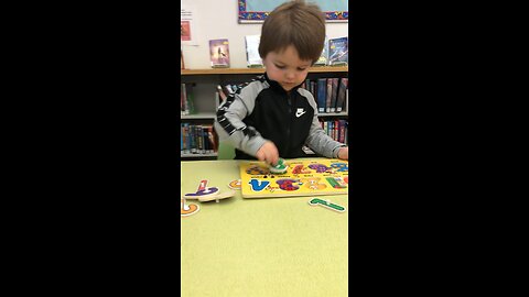 At the library , doing a number puzzle with CJ . It was a bit challenging but he succeeded.