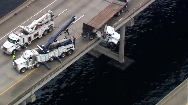 Aerial video: Truck hangs off I-75 bridge in Manatee County