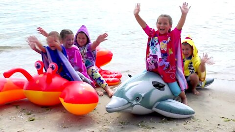 Funny kids play and dance on the sea