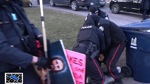 Toronto police arrest peaceful protester in front of Premier Doug Ford's house. Toronto, Canada March 4, 2021