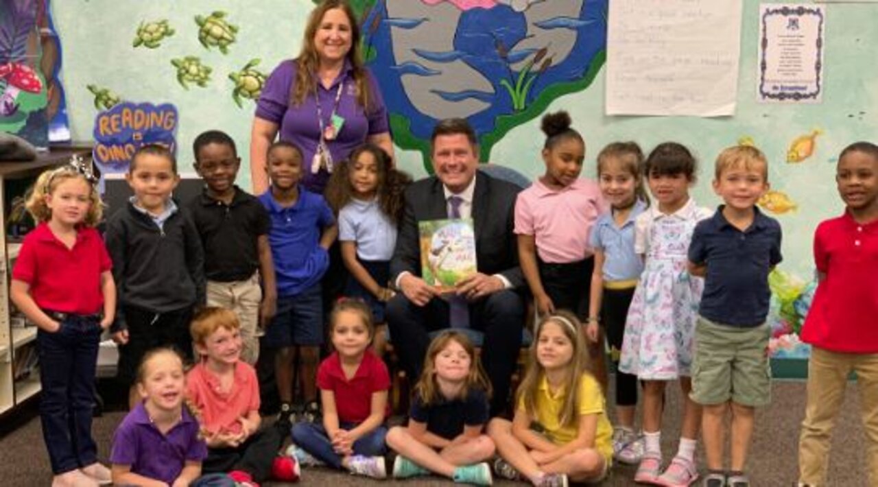 WPTV anchor Mike Trim reads to students at Village Green Environmental Studies School