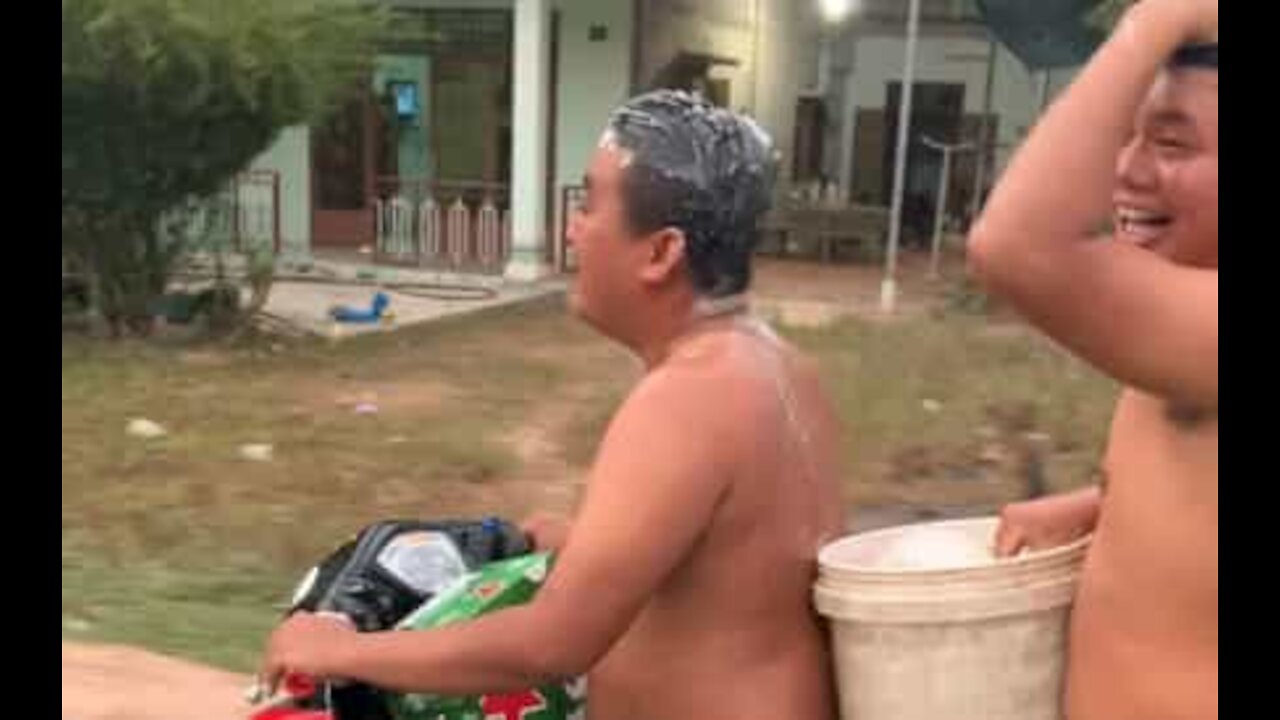 Guys wash their hair while riding motorbike