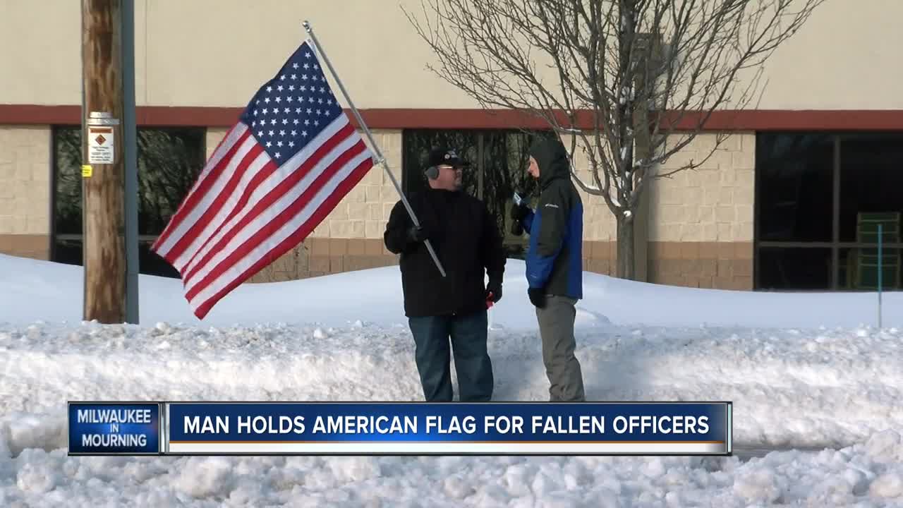 Man holds American Flag for fallen officers