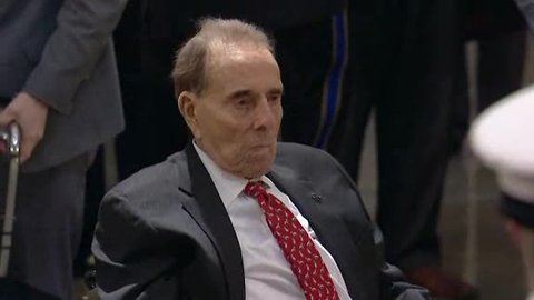 Bob Dole stands to salute former President Bush