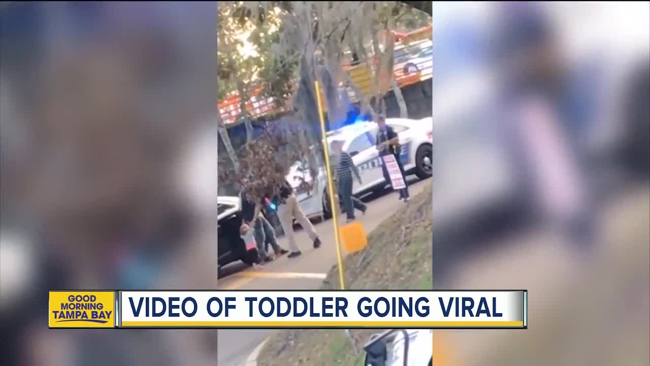 Video: Toddler walks with her hands up toward police officer
