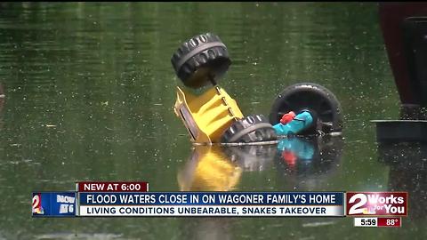 Flood waters close in on Wagoner family's home