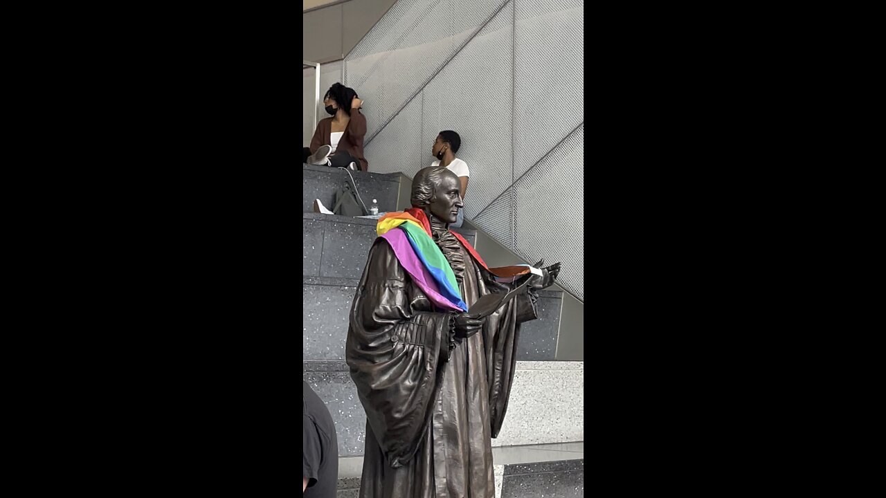 Gay Pride Flag on Founding Father John Jay at John Jay College. This is a statue of a dead person