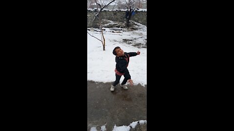 Little boys playing with ice