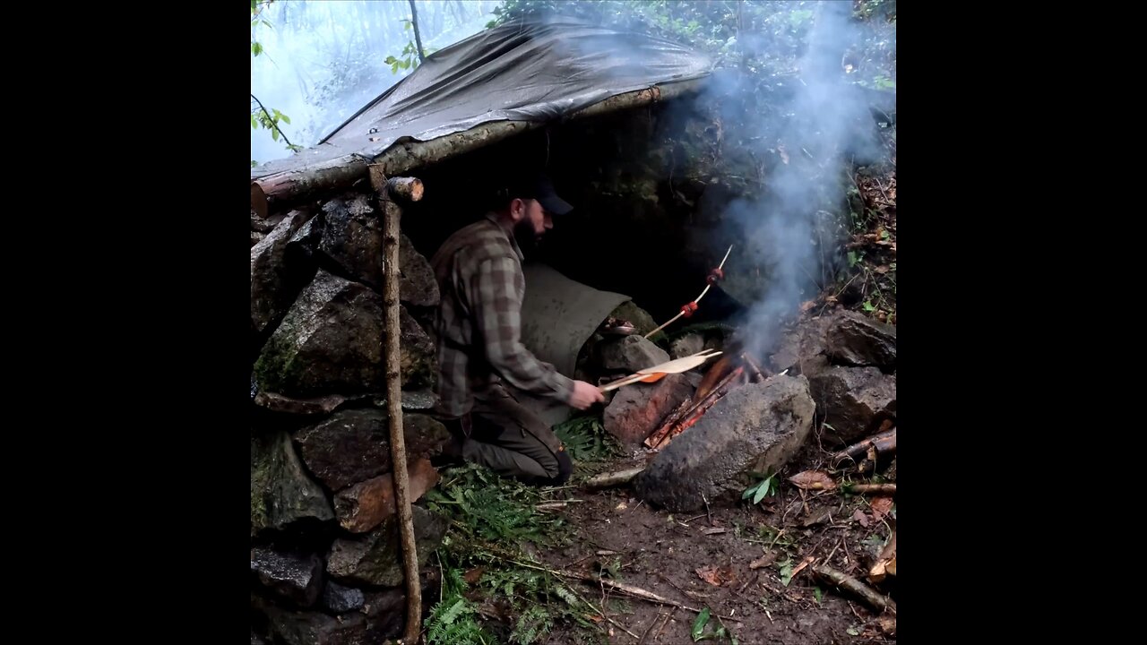 Rain camping and campfire cooking at my bushcraft shelter