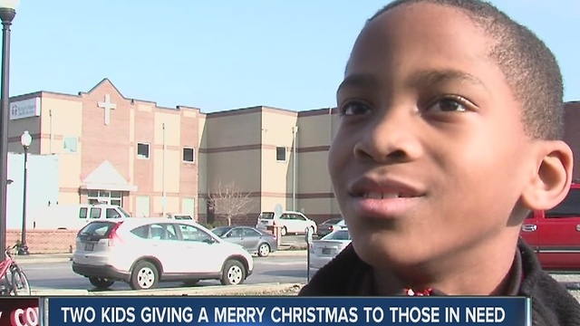 Two kids hands out items to the homeless