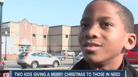 Two kids hands out items to the homeless