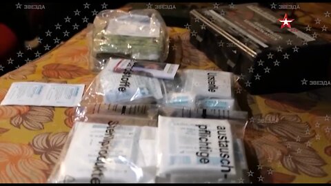 A reporter in the Lugansk shows off the acquired weapons of the LPR