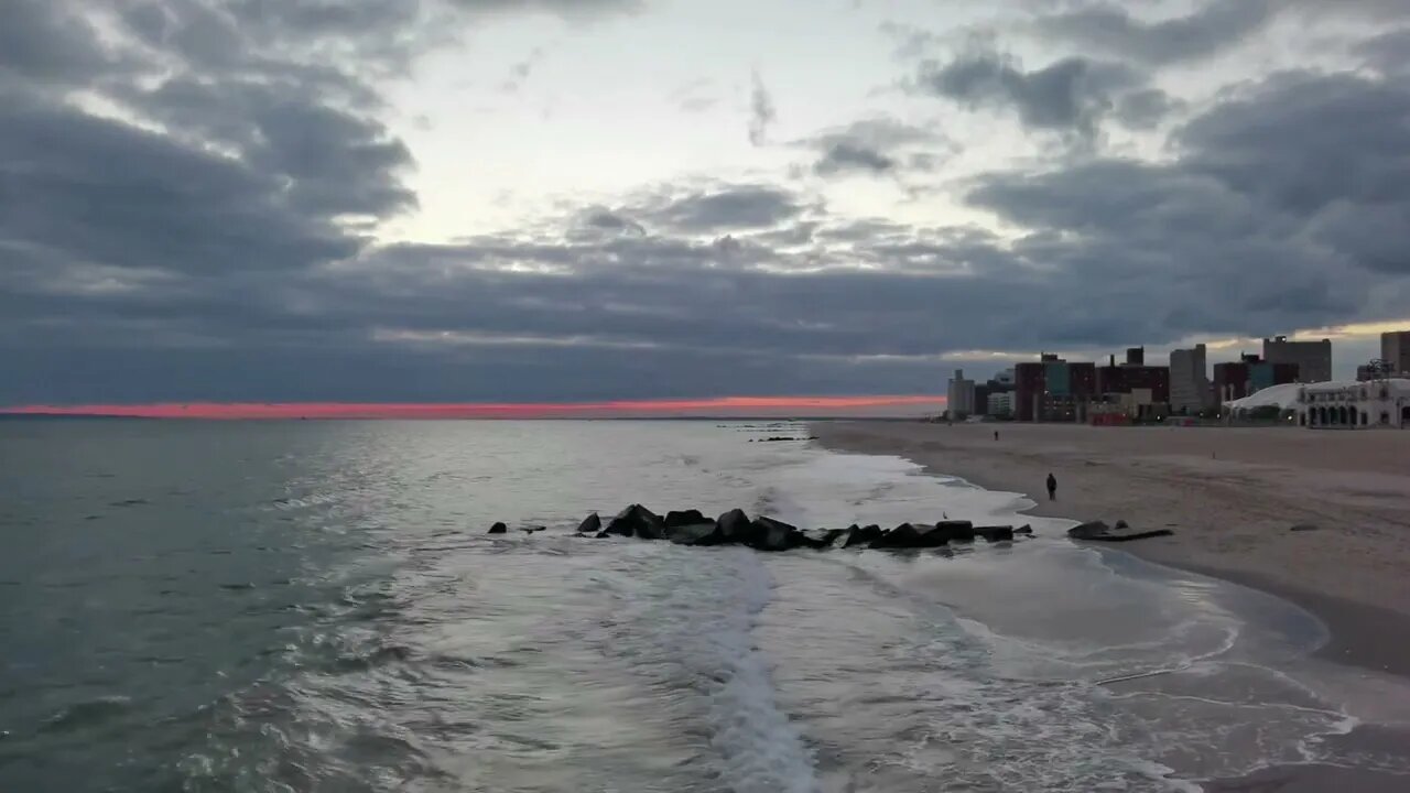 Waves rolling in at sunset on the beach