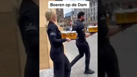 Owners of the 'Majestic' bar, in the center of Amsterdam, on Dam square, serve drinks to farmers