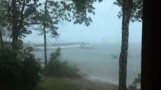 Strong winds and rain blow across lake during Ontario storm