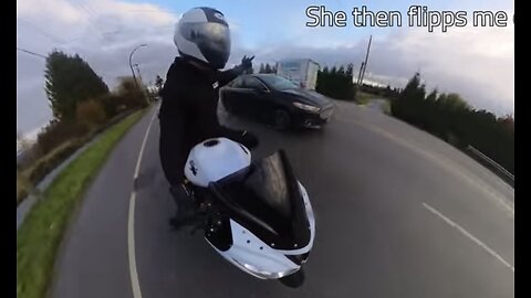 Woman flips off biker for no reason