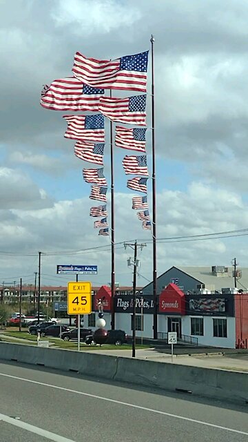 8 flags on one flagpole at siemonds in Dallas Texas