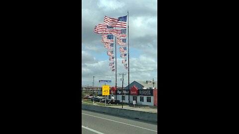 8 flags on one flagpole at siemonds in Dallas Texas