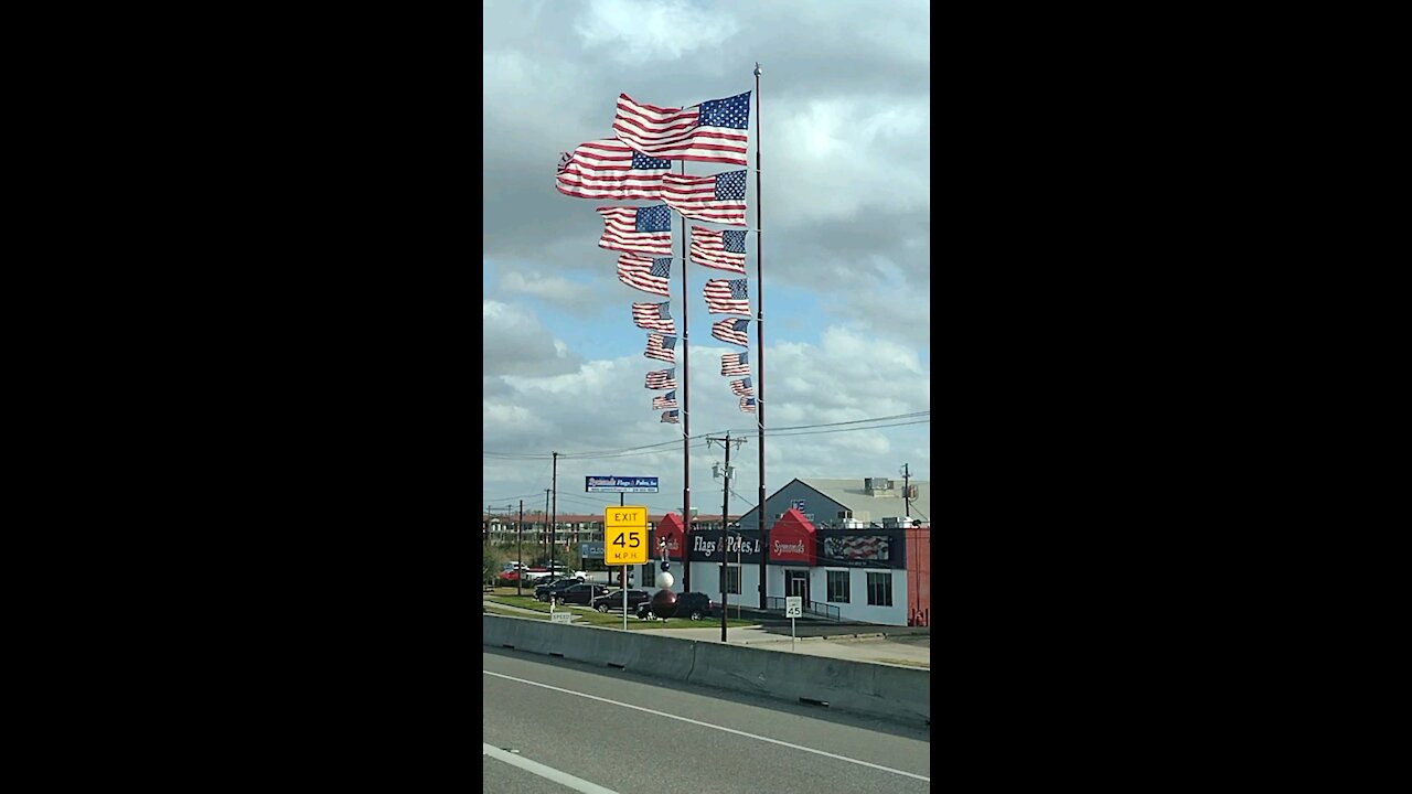 8 flags on one flagpole at siemonds in Dallas Texas
