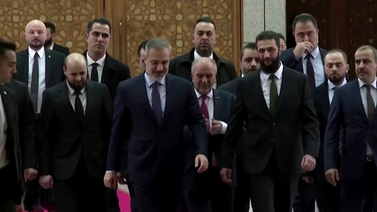 Turkey's foreign minister meets with Syria's de facto ruler