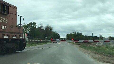 SD9 Escanaba & Lake Superior pulling cars across CO RD 426 to the Escanaba shop